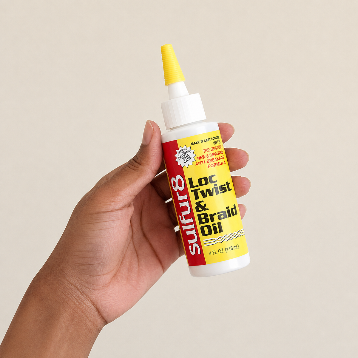 Sulfur8 Loc Twist & Braid Oil 4 oz held in hand with applicator tip for braids, locs, twists and scalp care