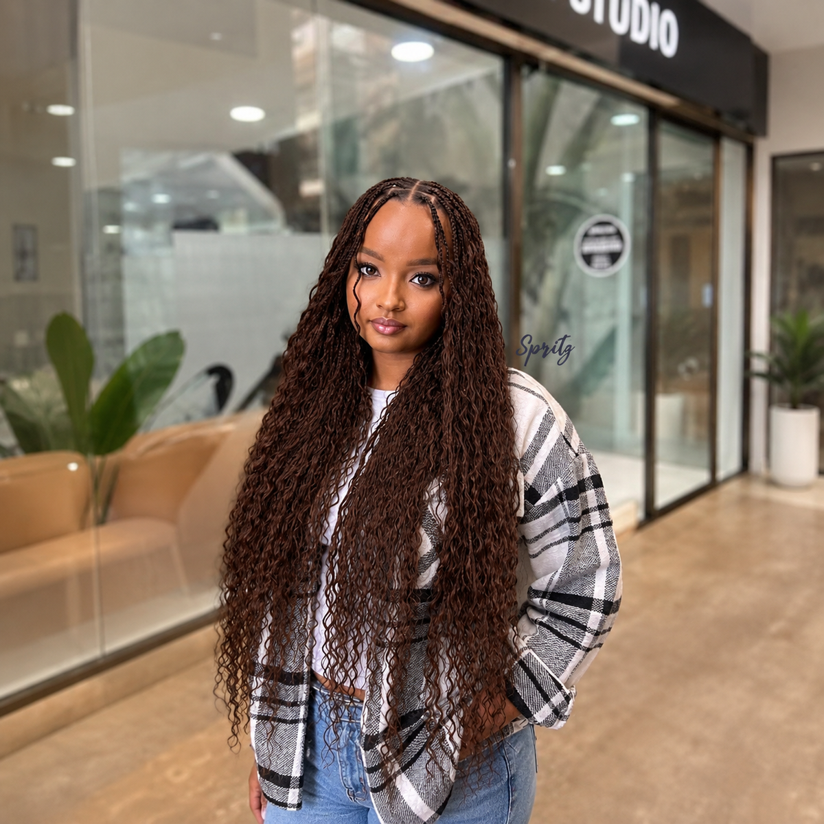 Woman wearing full-length Dark Brown #2 Wet & Wavy human hair in long boho braids.