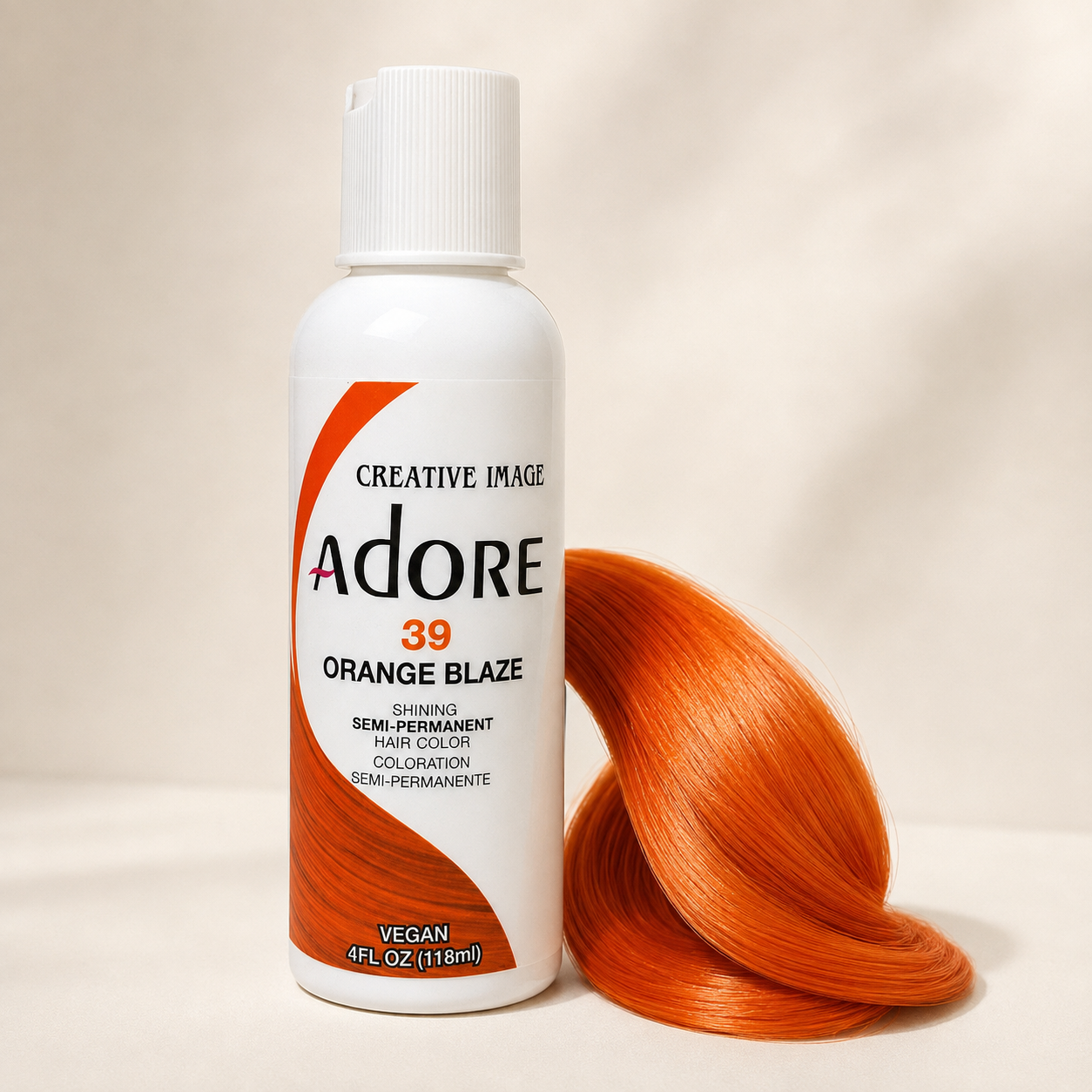 Adore Orange Blaze semi-permanent hair dye beside a glossy bright-orange hair-color swatch