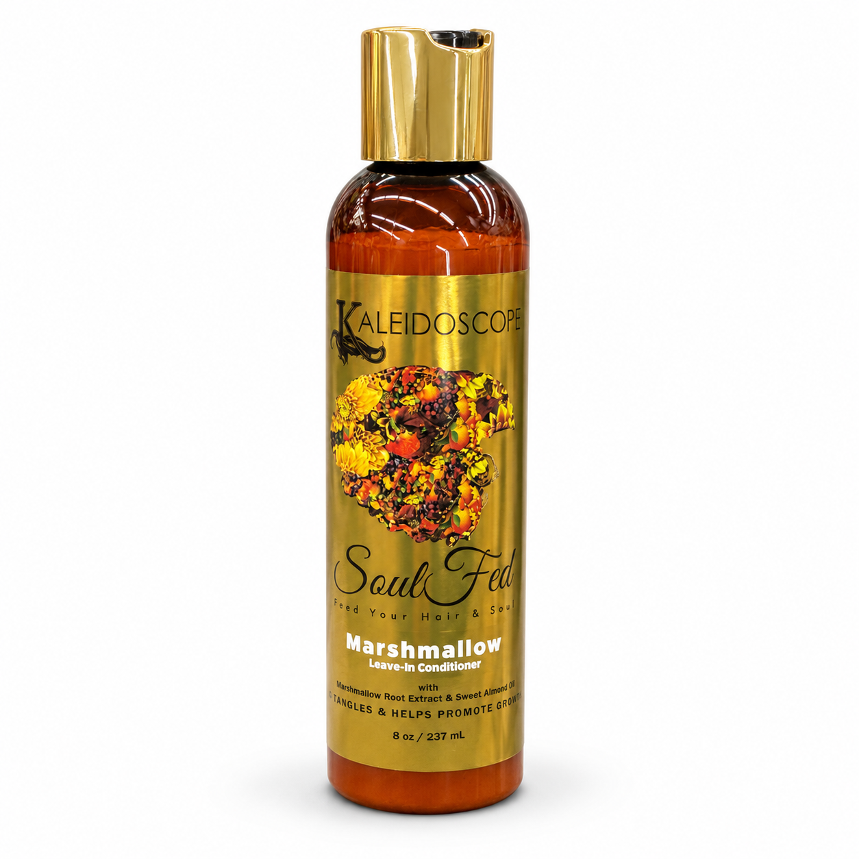 A bottle of Kaleidoscope Soul Fed Marshmallow Leave-in Conditioner, featuring an amber bottle with a metallic gold cap and a gold label decorated with a marshmallow graphic.