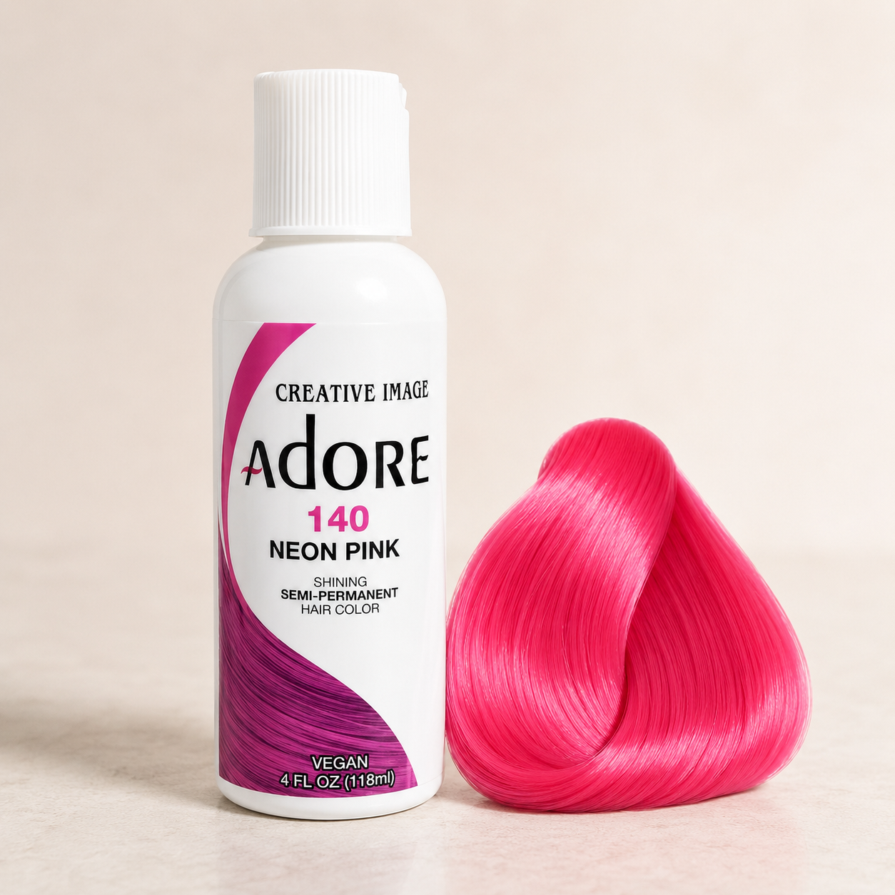 Adore Neon Pink semi-permanent hair dye beside a glossy bright-pink hair-color swatch