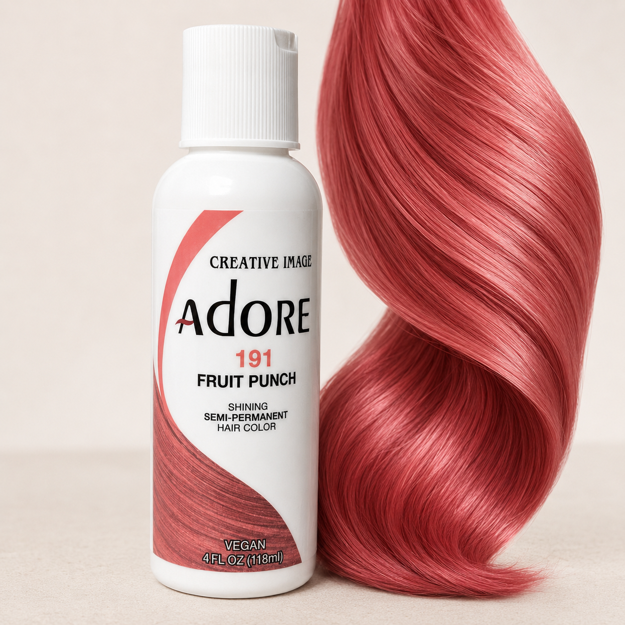 Adore Fruit Punch semi-permanent hair dye beside a glossy rose-coral hair-color swatch