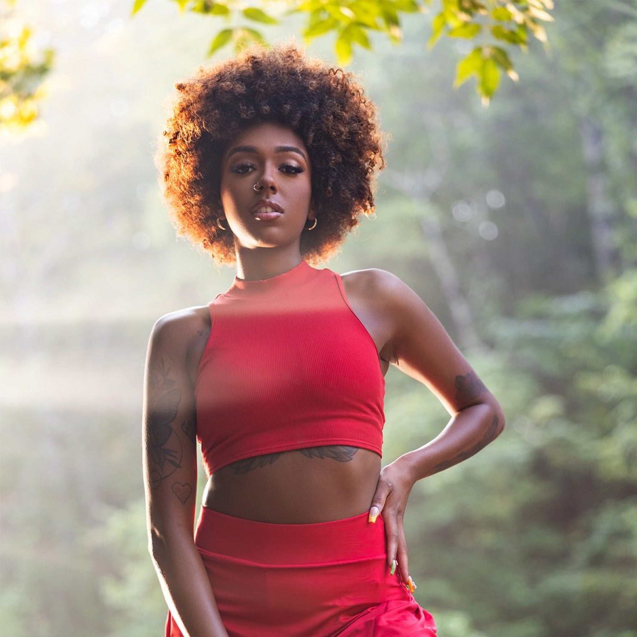 Woman in a red outfit standing in a forest